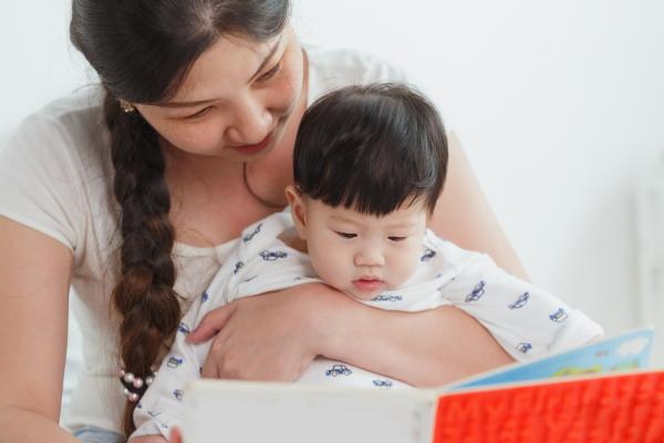 Female adult reading to baby